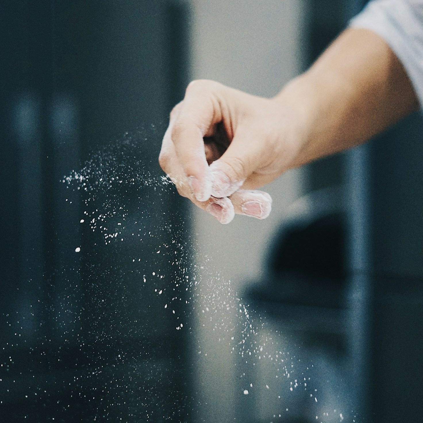 Community members collaborating in a modern kitchen space, sharing recipes and cooking techniques